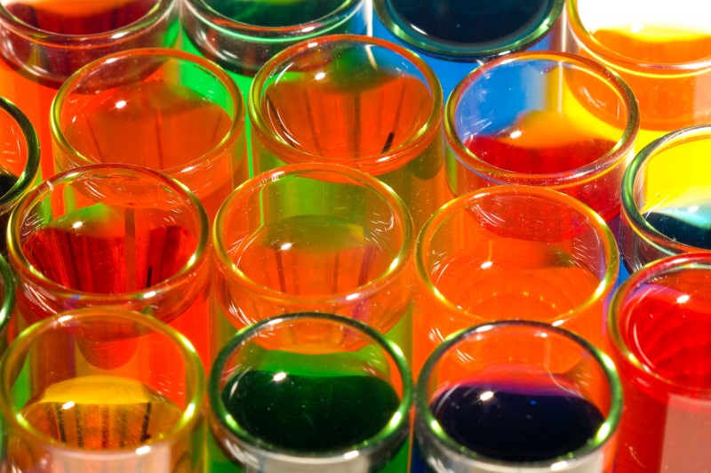 Scientific glassware filled with different coloured liquids